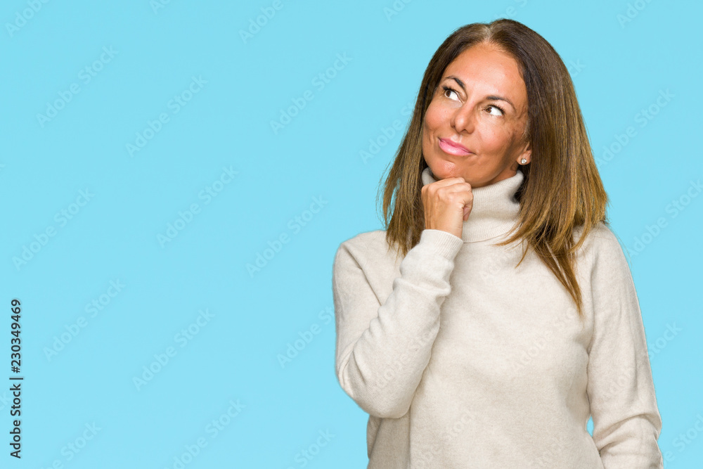 Beautiful middle age adult woman wearing winter sweater over isolated background with hand on chin thinking about question, pensive expression. Smiling with thoughtful face. Doubt concept. Beautiful middle age adult woman wearing winter sweater over isolated background with hand on chin thinking about question, pensive expression. Smiling with thoughtful face. Doubt concept.