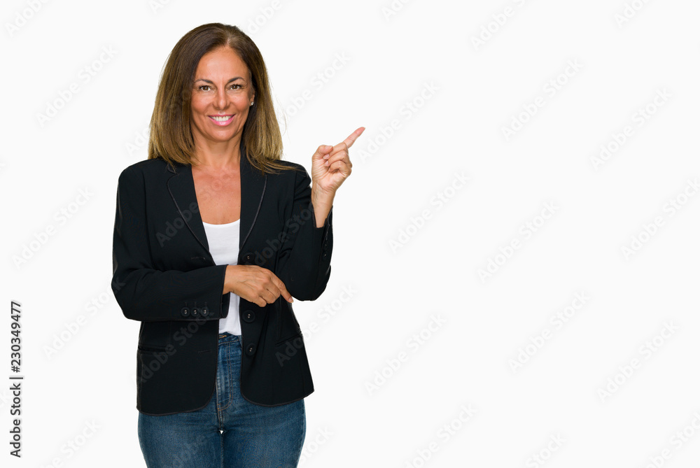 Beautiful middle age business adult woman over isolated background with a big smile on face, pointing with hand and finger to the side looking at the camera.