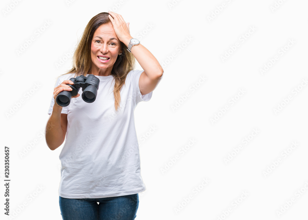Middle age hispanic woman looking through binoculars over isolated background stressed with hand on head, shocked with shame and surprise face, angry and frustrated. Fear and upset for mistake. Middle age hispanic woman looking through binoculars over isolated background stressed with hand on head, shocked with shame and surprise face, angry and frustrated. Fear and upset for mistake.