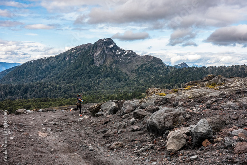 Young female trail runner training on Villarica Volcano, Chile