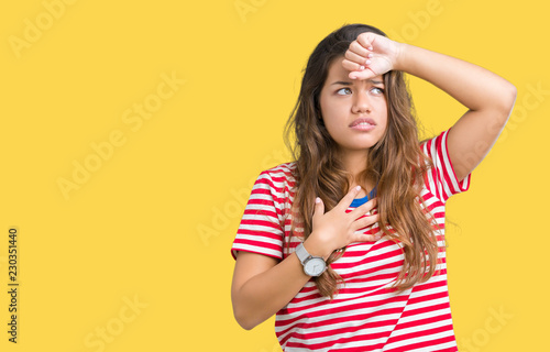 Young beautiful brunette woman wearing stripes t-shirt over isolated background Touching forehead for illness and fever, flu and cold, virus sick