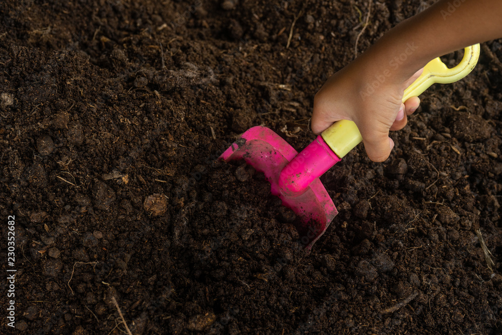 Hand holding Small plastic toy Shoveling Hand holding Small plastic toy Shoveling
