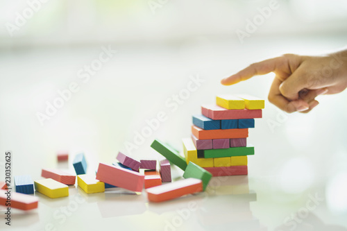 Closeup of asian kid's hand playing wood blocks stack game