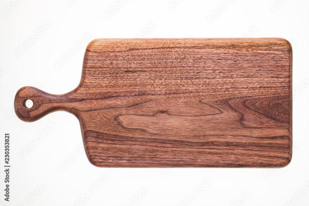 Handmade walnut chopping board, natural texture element background.