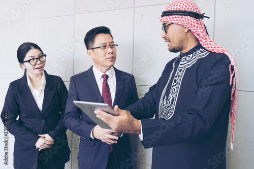 Arabic business people talking The economic fluctuation of the country may affect the investment while discussing with Asia Partner Business teamwork trust partnership group of Asian business people