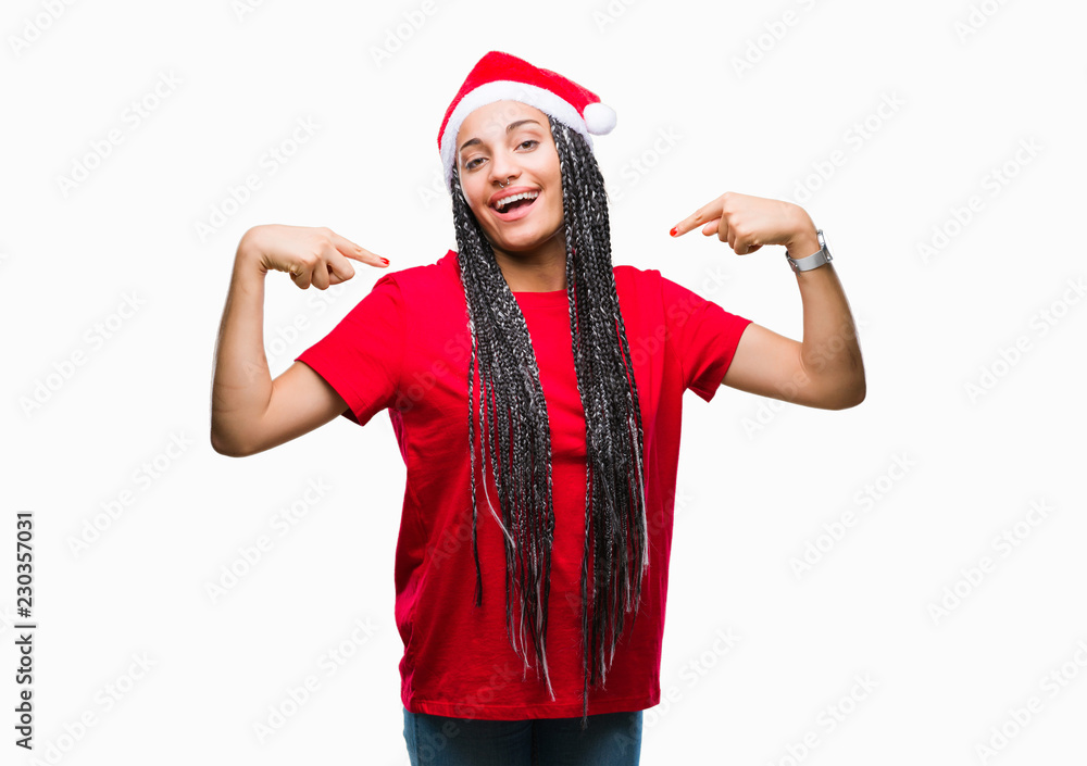 Young braided hair african american girl wearing christmas hat over isolated background looking confident with smile on face, pointing oneself with fingers proud and happy. Young braided hair african american girl wearing christmas hat over isolated background looking confident with smile on face, pointing oneself with fingers proud and happy.