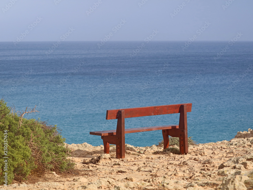 single bench in the park Cavo Greco in Ayia Napa, cyprus overlooking the mediterranean Sea