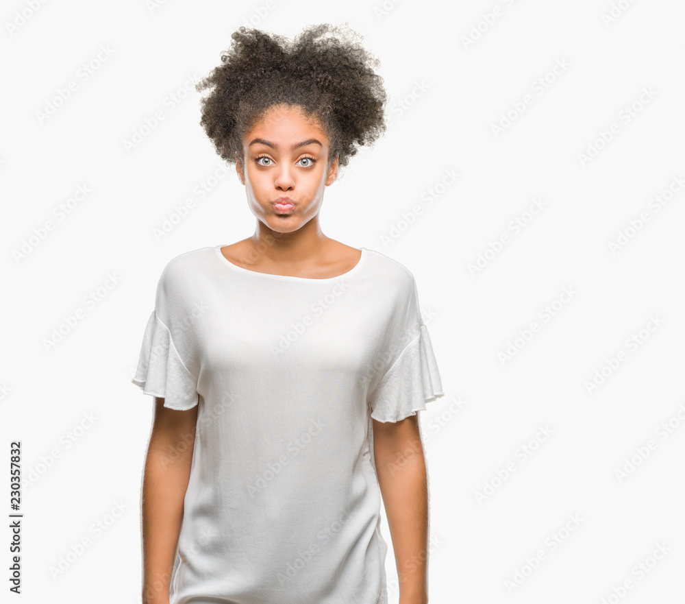Young afro american woman over isolated background puffing cheeks with funny face. Mouth inflated with air, crazy expression. Young afro american woman over isolated background puffing cheeks with funny face. Mouth inflated with air, crazy expression.