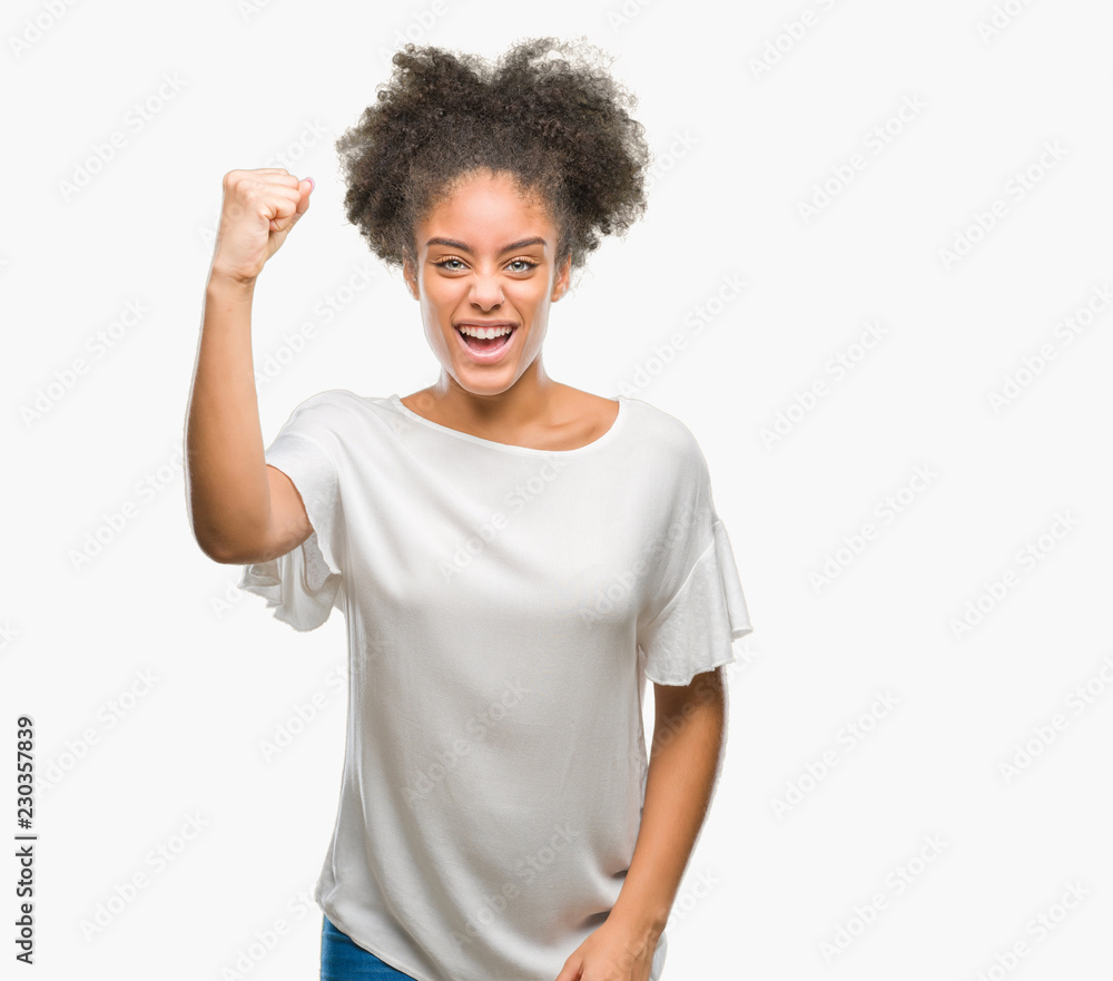 Young afro american woman over isolated background angry and mad raising fist frustrated and furious while shouting with anger. Rage and aggressive concept. Young afro american woman over isolated background angry and mad raising fist frustrated and furious while shouting with anger. Rage and aggressive concept.