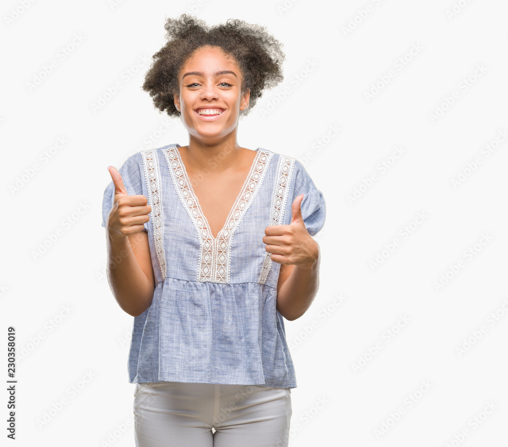 Young afro american woman over isolated background success sign doing positive gesture with hand, thumbs up smiling and happy. Looking at the camera with cheerful expression, winner gesture. Young afro american woman over isolated background success sign doing positive gesture with hand, thumbs up smiling and happy. Looking at the camera with cheerful expression, winner gesture.