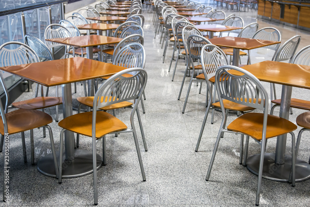 rows of metal chairs and tables in an outdoor cafe