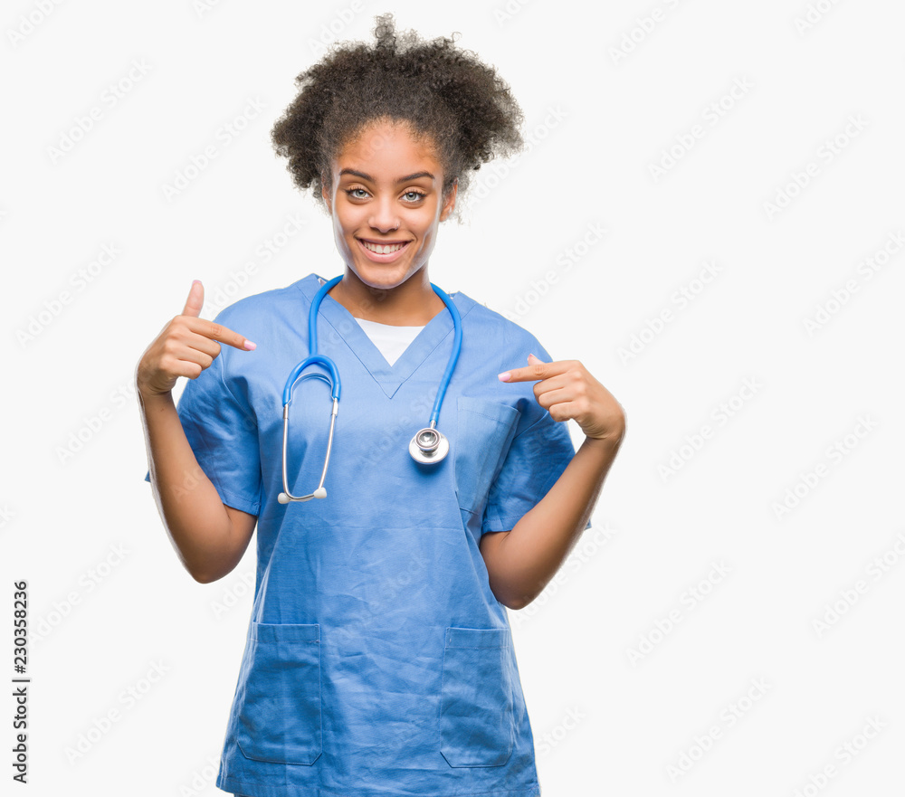 Young afro american doctor woman over isolated background looking confident with smile on face, pointing oneself with fingers proud and happy. Young afro american doctor woman over isolated background looking confident with smile on face, pointing oneself with fingers proud and happy.