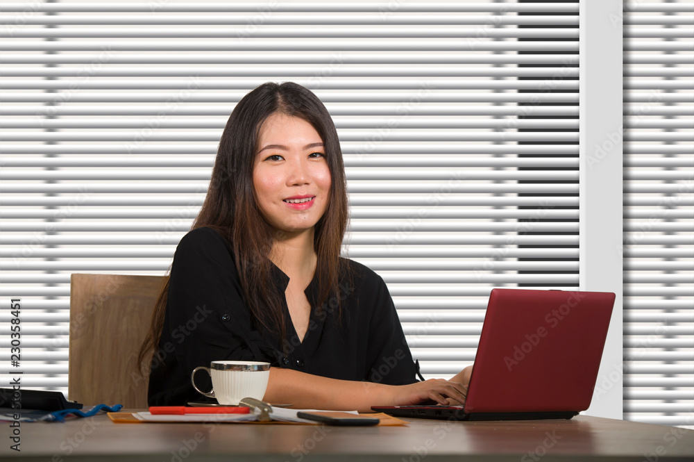 young beautiful and successful Asian Chinese business woman working confident at modern office computer desk in female businesswoman success young beautiful and successful Asian Chinese business woman working confident at modern office computer desk in female businesswoman success