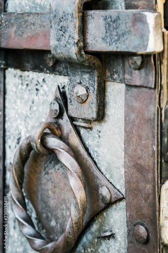 old and rusty latch and handle on metal door. old castle, house, basement or room door