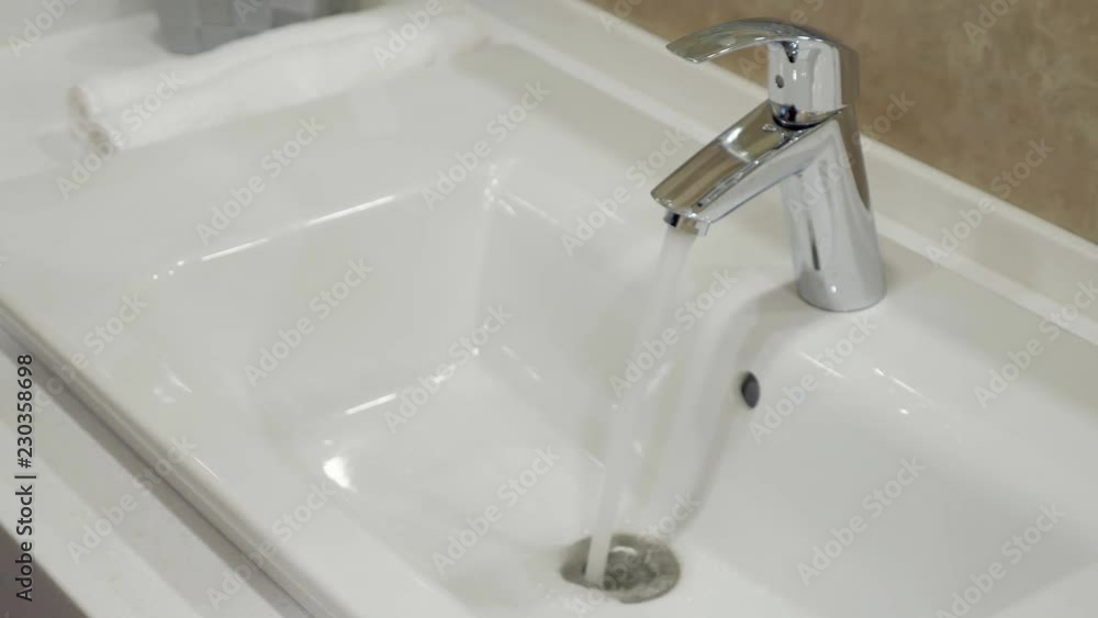 Open chrome faucet washbasin in bathroom. Open chrome faucet washbasin in bathroom.