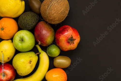 Variety of fruits isolated on black background. Top view of fresh fruits