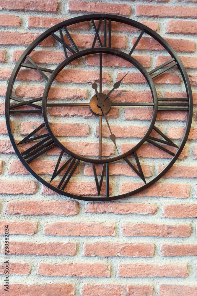 Metal Clock on Red Brick Wall Background