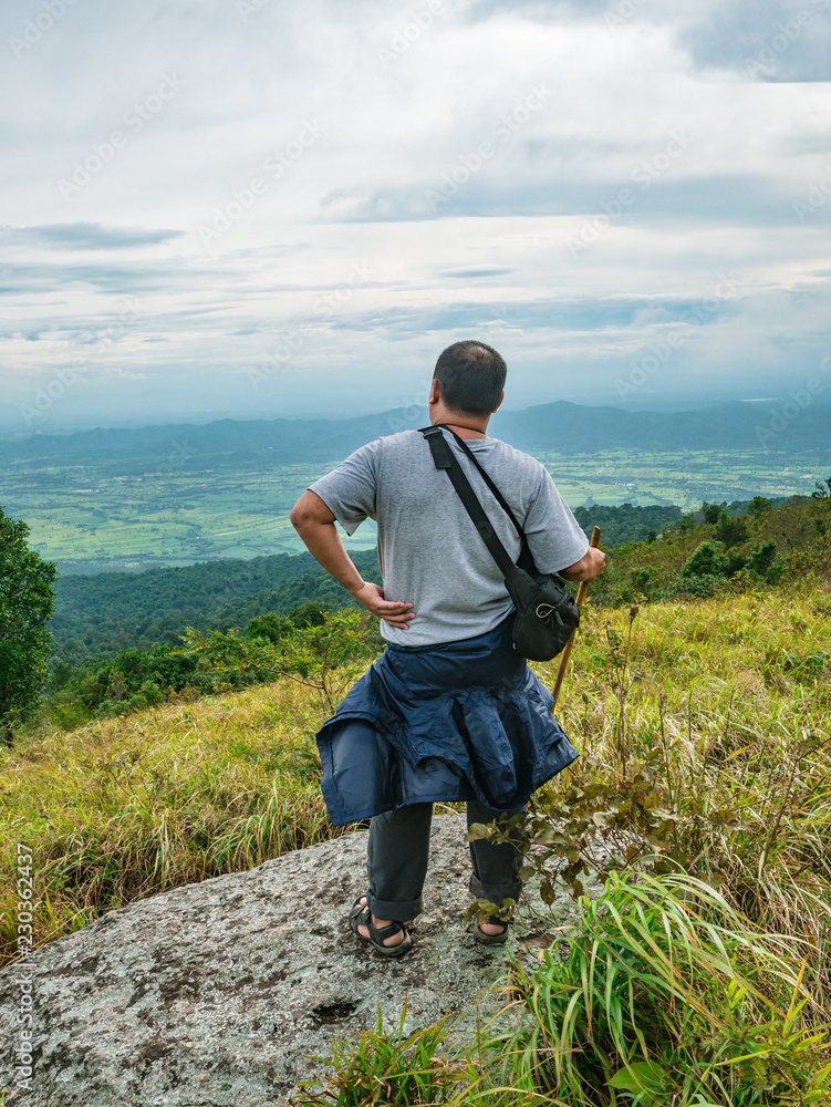 Asian Fat traveler trekking on Khao Luang mountain in Ramkhamhaeng National Park,Sukhothai province Thailand Asian Fat traveler trekking on Khao Luang mountain in Ramkhamhaeng National Park,Sukhothai province Thailand