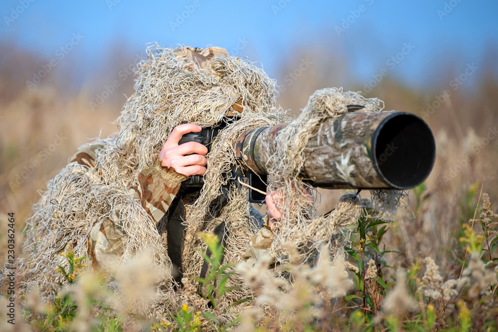 Premium Photo | Camouflage wildlife photographer in the ghillie suit  working in the wild