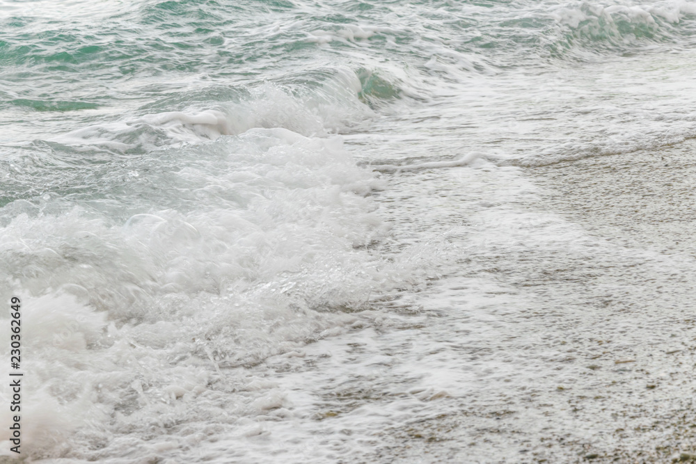 The wave covers the pebble beach. The wave covers the pebble beach.