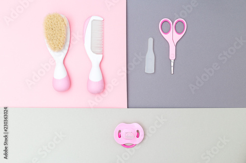 Baby accessories and  baby pacifier on material design background. Flat lay