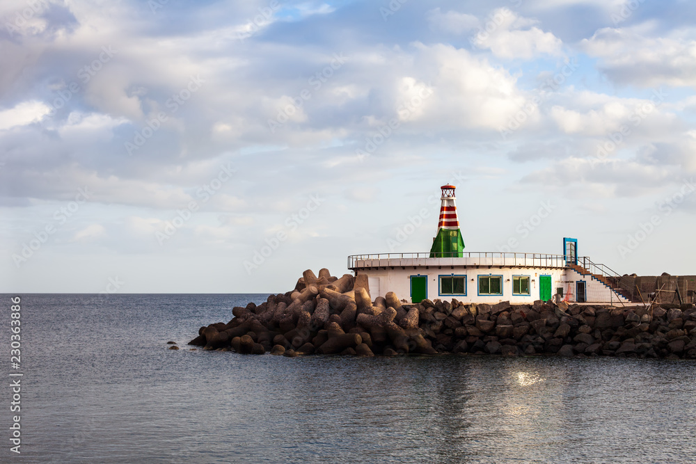 Small lighthouse on ocean beach