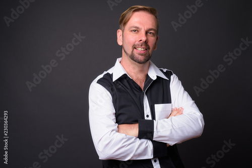 Tableau sur toile Blond bearded businessman with goatee against gray background