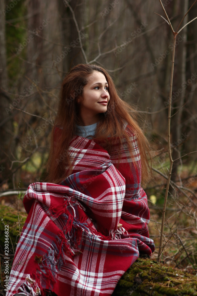 beautiful girl covered with a blanket on vacation in the woods beautiful girl covered with a blanket on vacation in the woods