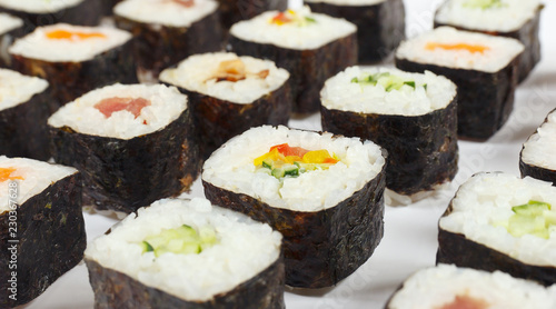 Assorted asian sushi on a white background close up.