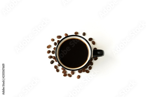 Black coffee in a white ceramic mug and grains on a white background.