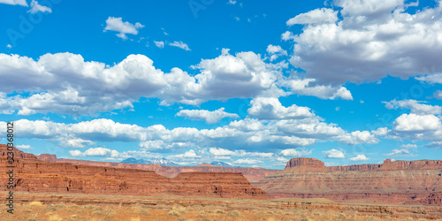 Dramatic canyon and mountain peaks under blue sky © Jason