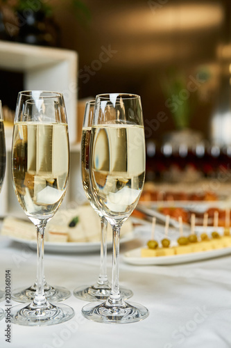 champagne and sparkling wine glasses at banquet night time party new year corporate party concept