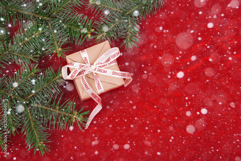 Christmas gifts with red ribbon on red background with decorations. Christmas background with copy space.