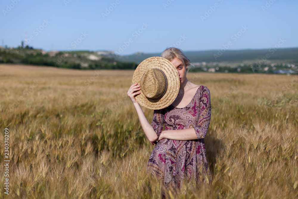 a woman farmer in a field of ripe wheat and rye