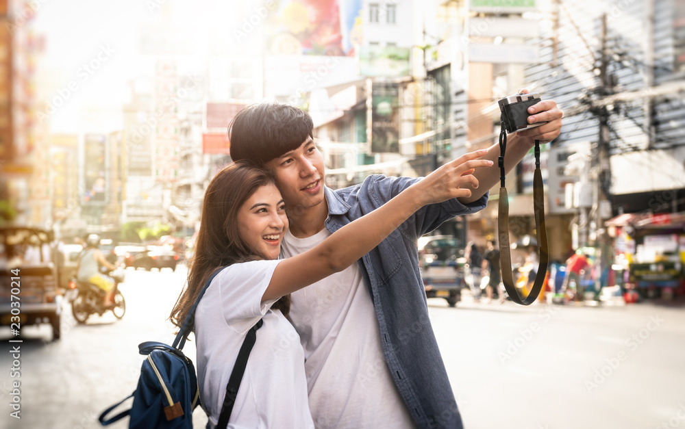 Φωτογραφία Young man is taking a photo of his friends at the street in Thailand