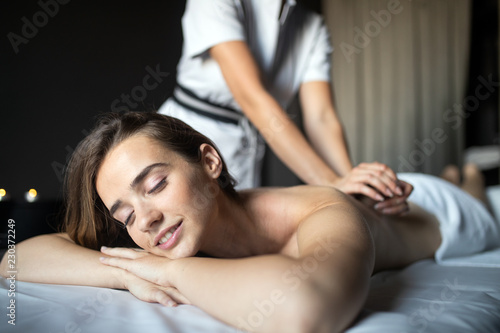 Young woman having massage in beauty salon