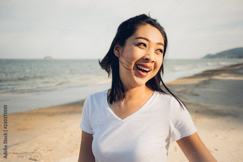 Happy woman go for a walk on the beach.