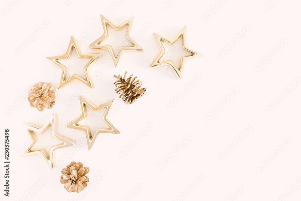 Christmas composition. Xmas gold decorations on pastel pink background. Flat lay, top view, copy space Christmas composition. Xmas gold decorations on pastel pink background. Flat lay, top view, copy space