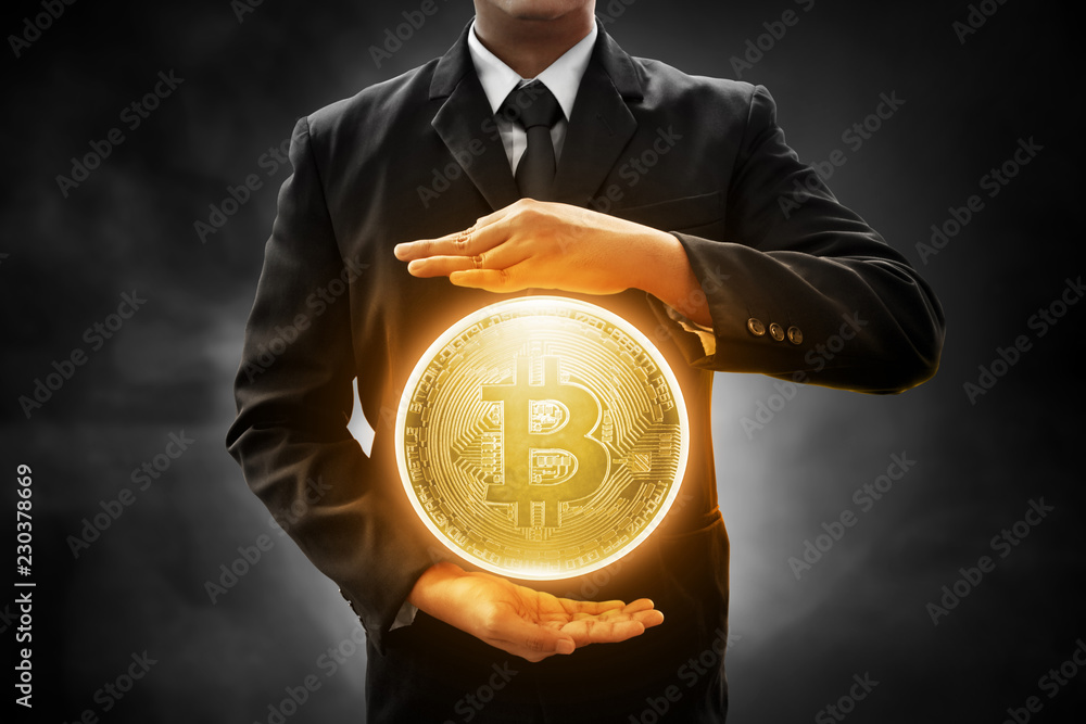 Fotografie Businessman holding bitcoin