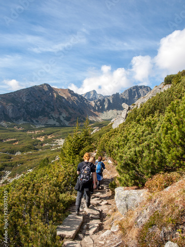 Hikers on trail at Great Cold Valley, Vysoke Tatry (High Tatras), Slovakia. The Great Cold Valley is 7 km long valley, very attractive for tourists
