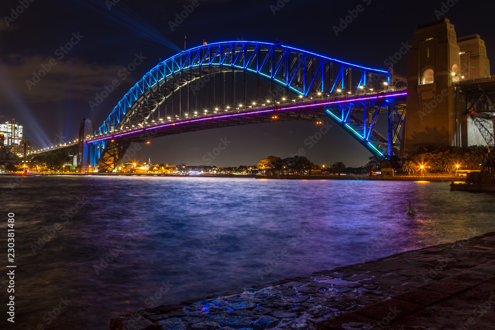 Sydney Harbour Bridge lit up in blue colours