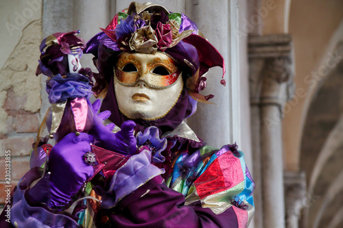 Carnival lilac mask and costume at the traditional festival in Venice, Italy