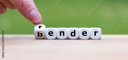 Hand is turning dice and changes the word fender to bender