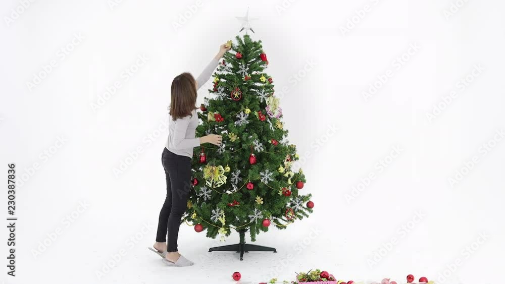 Two beautiful Asian women decorating the Christmas tree with lots of charming decorations, enjoying their time for the special Christmas holiday. Time lapse video. Two beautiful Asian women decorating the Christmas tree with lots of charming decorations, enjoying their time for the special Christmas holiday. Time lapse video.