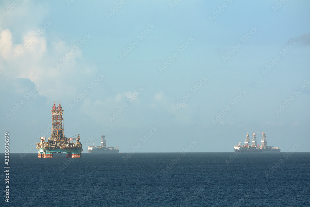Offshore oil rig and drilling vessels in Chaguaramas Bay, Trinidad and Tobago working on oil industry project.