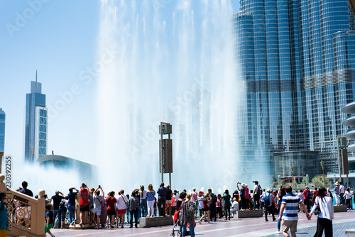 Dubai, United Arab Emirates - March 26, 2018: People gather around the Dubai mall fountain to see the water show
