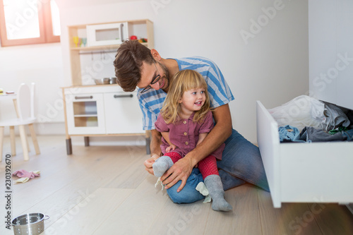 Father putting daughters socks on
