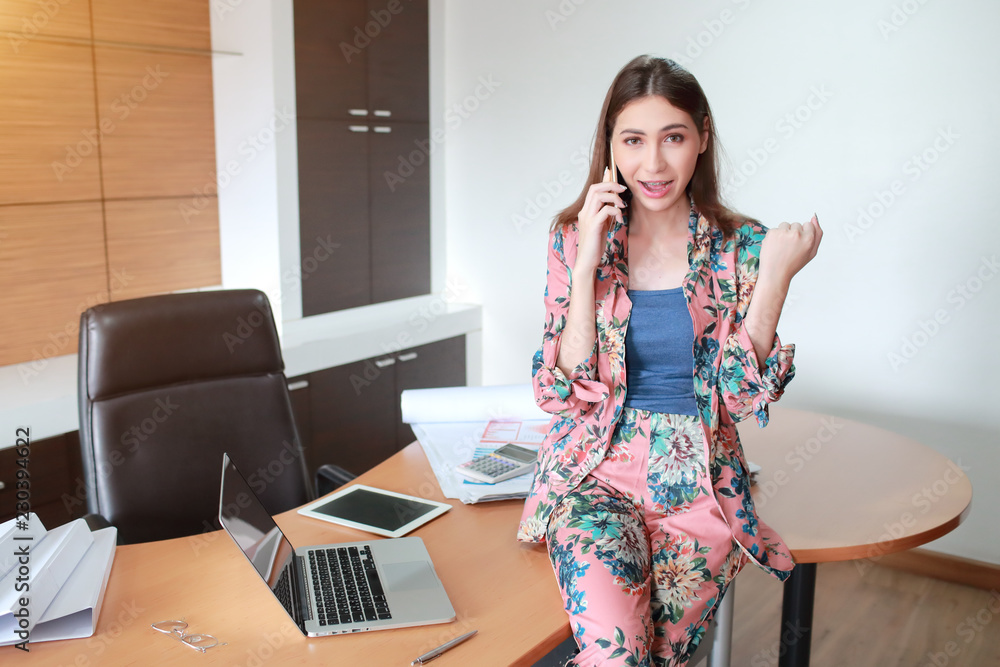 beautiful businesswoman model post using cell phone with labtop computer beautiful businesswoman model post using cell phone with labtop computer
