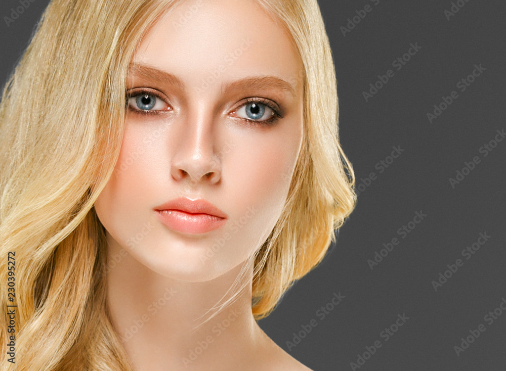 Blonde woman face closeup with healthy skin and beauty makeup Blonde woman face closeup with healthy skin and beauty makeup