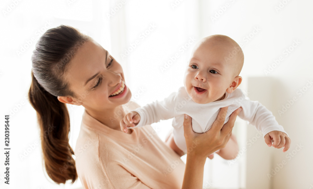 family, motherhood and people concept - happy mother playing with little baby boy at home family, motherhood and people concept - happy mother playing with little baby boy at home